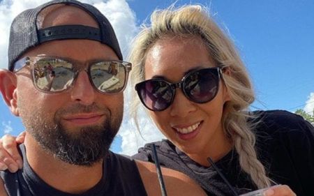 Karl Anderson and his wife Christine Bui pose for a picture.